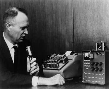 Dr. E. A. Quade demonstrates IBM Shoebox, an early speech-recognition machine